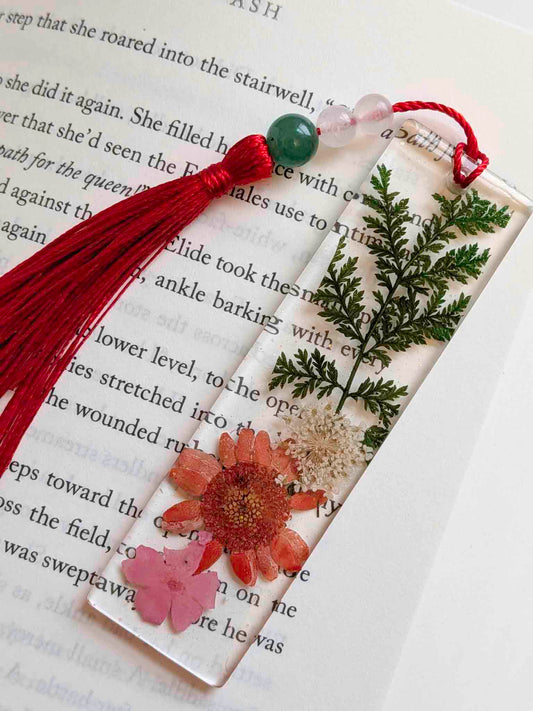Decorative bookmark with flowers and tassel on a book page