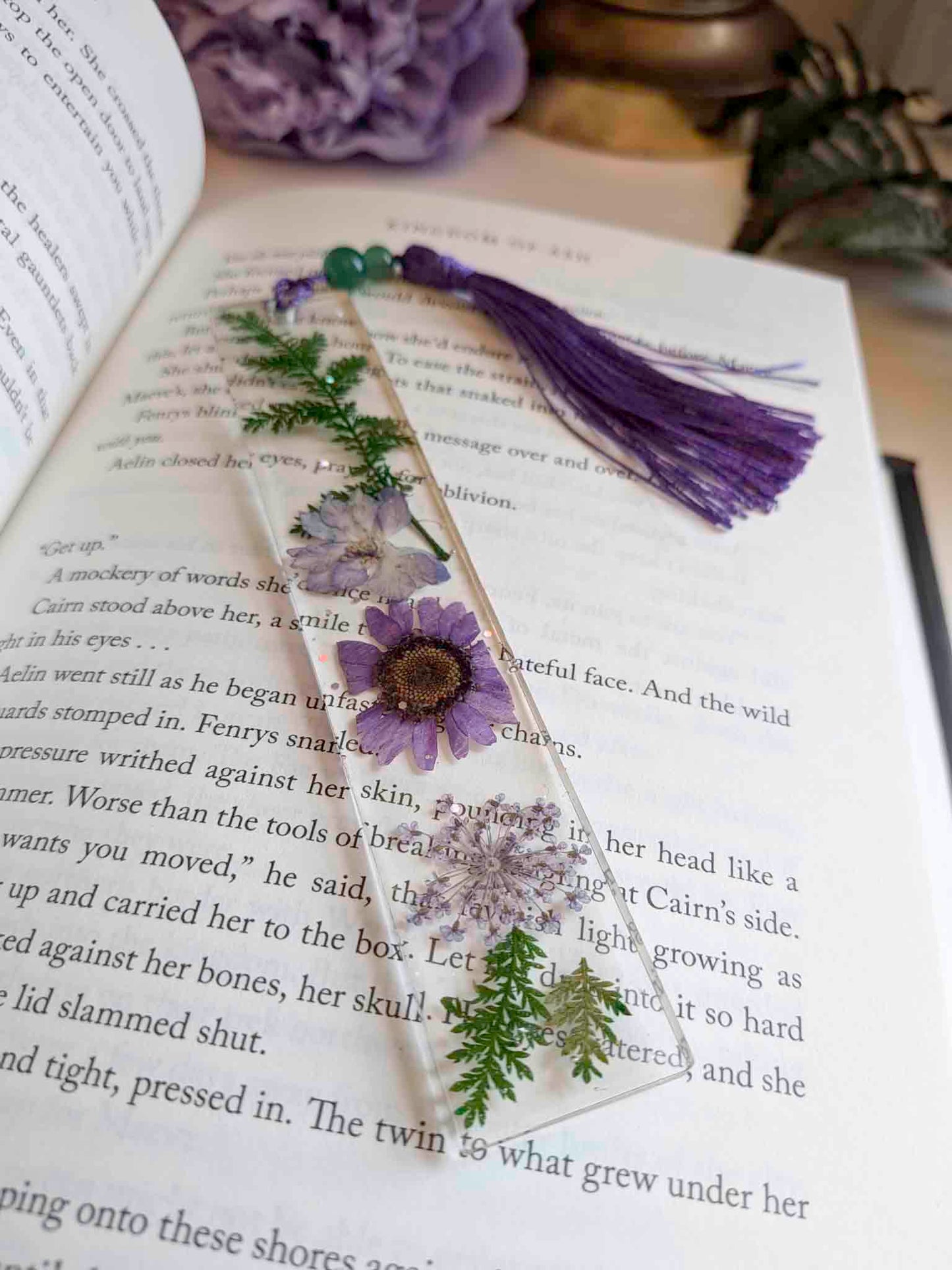 Decorative bookmark with flowers and tassel on an open book