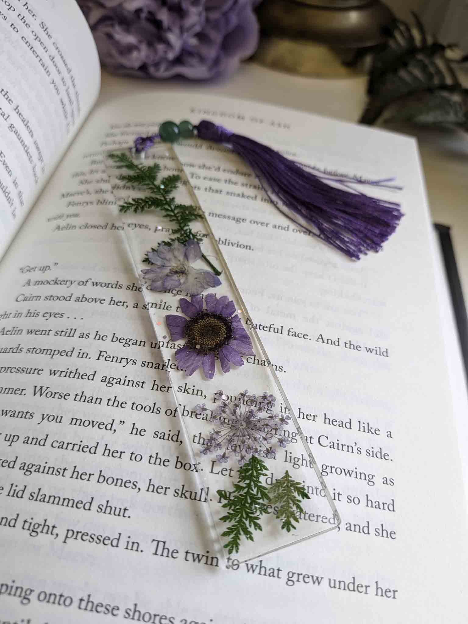Decorative bookmark with flowers and tassel on an open book