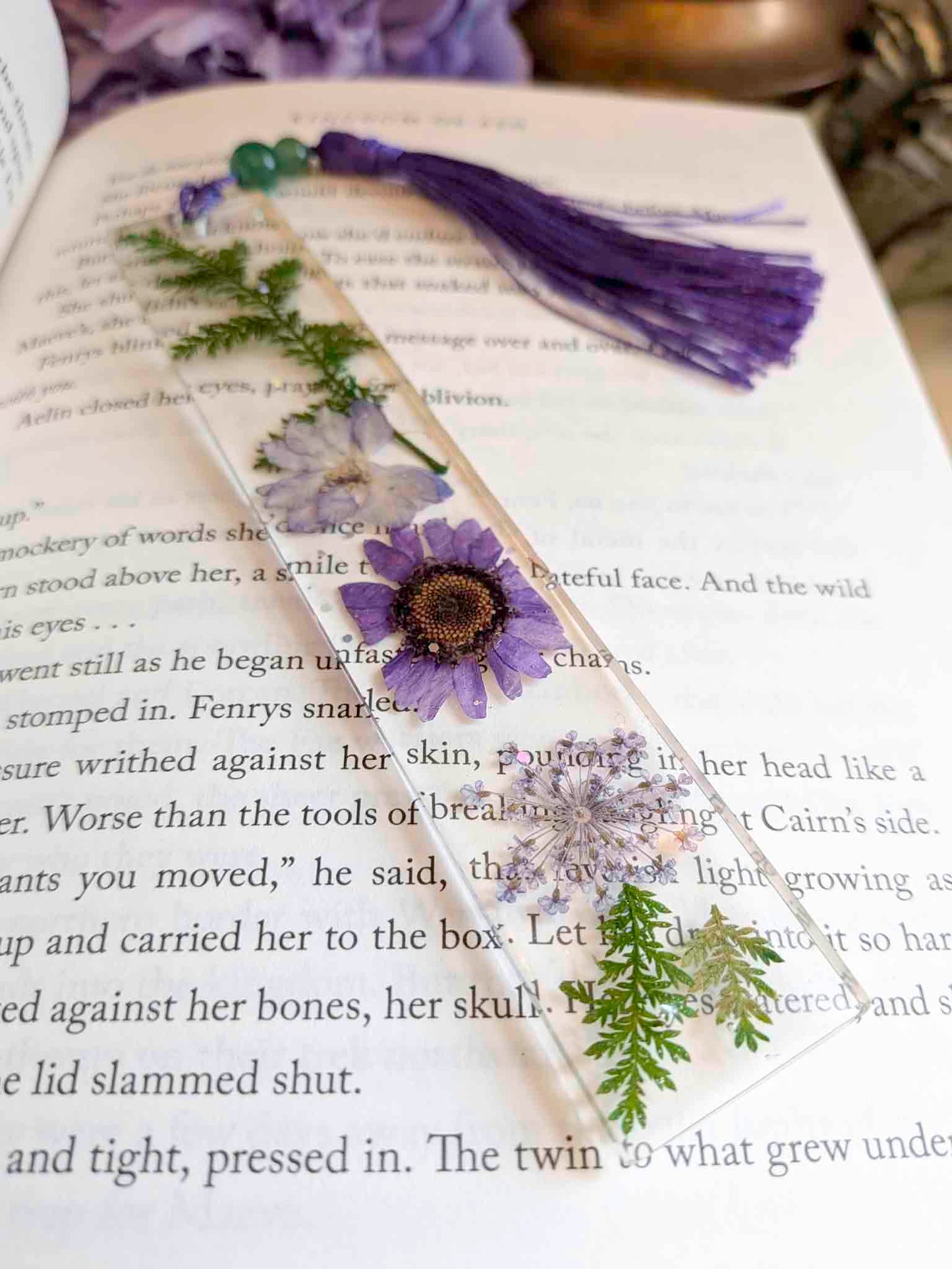 Floral bookmark with tassel on an open book