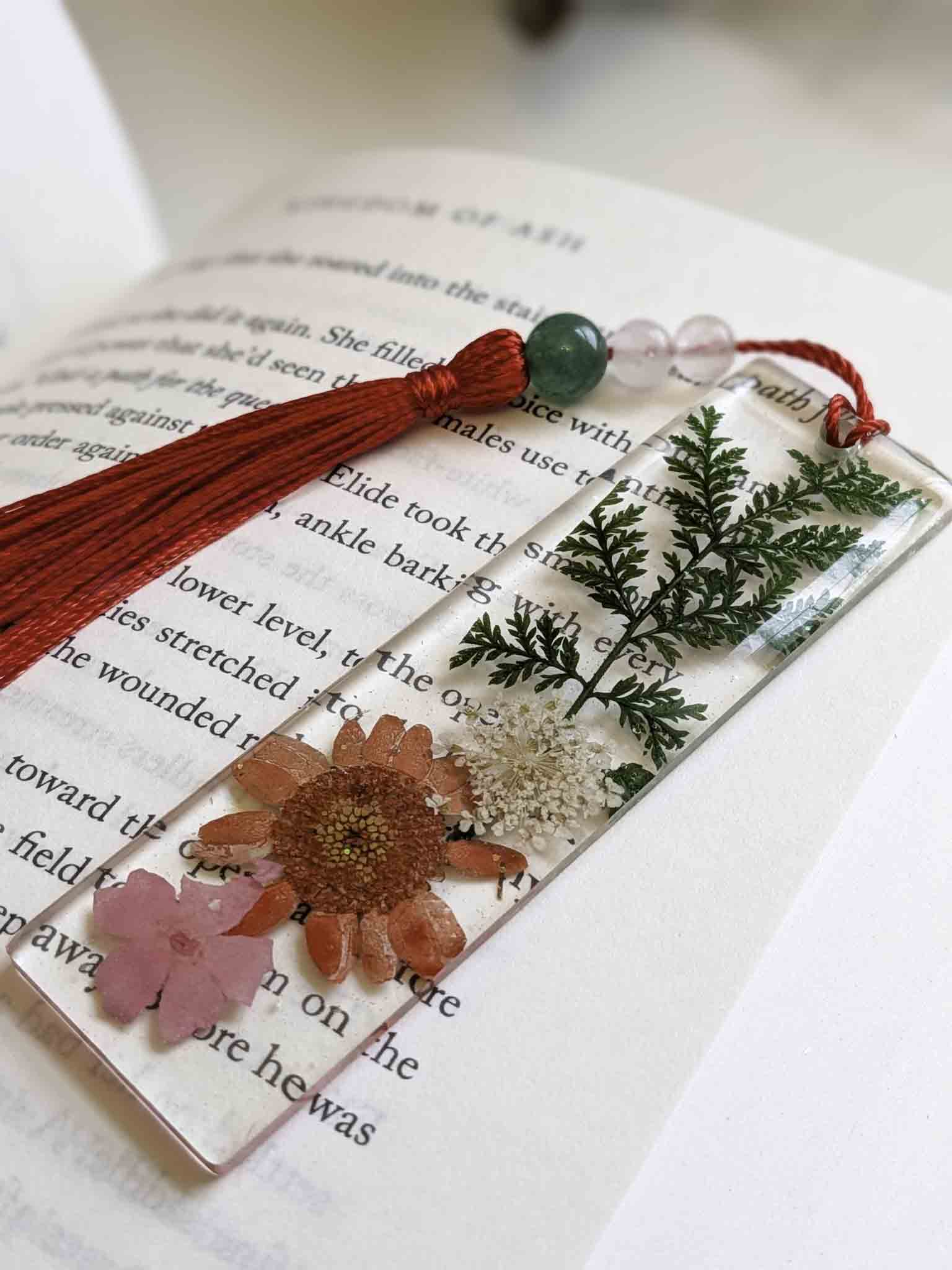 Decorative bookmark with flowers and tassel on an open book