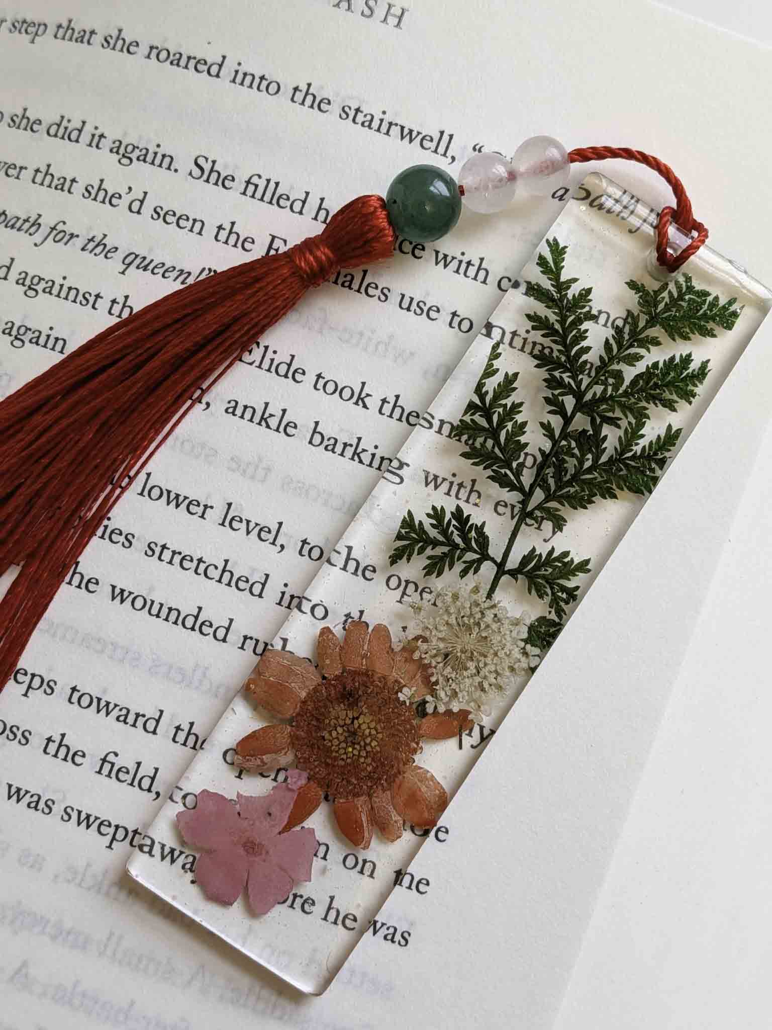Decorative bookmark with flowers and tassel on a book page