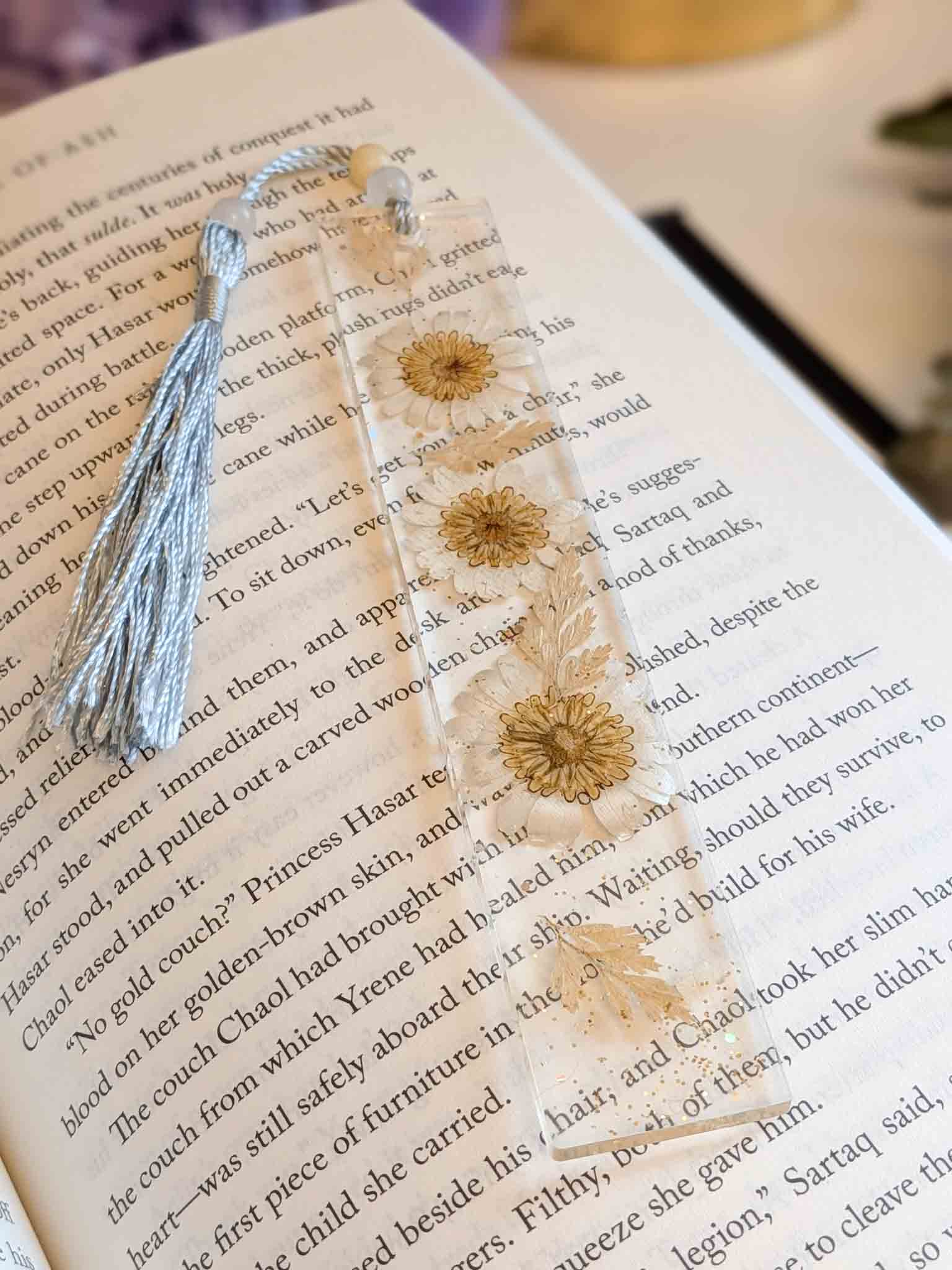Decorative earrings with floral design on a book page
