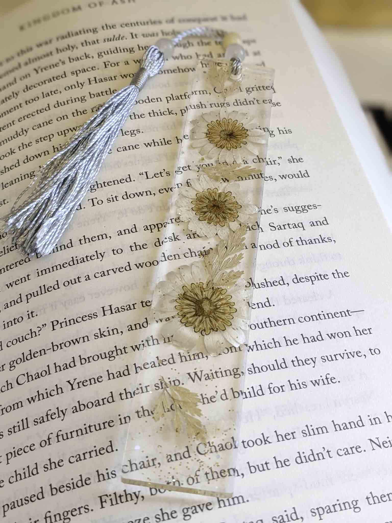 Decorative bookmark with floral design on an open book