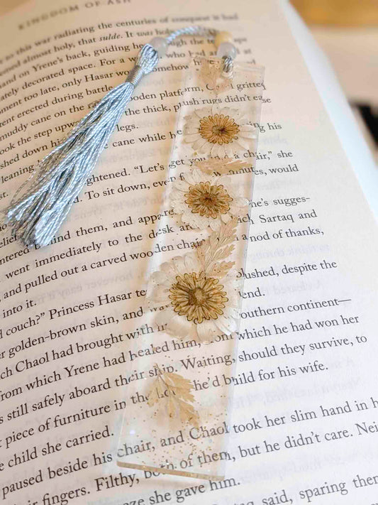 Decorative bookmark with floral design on an open book